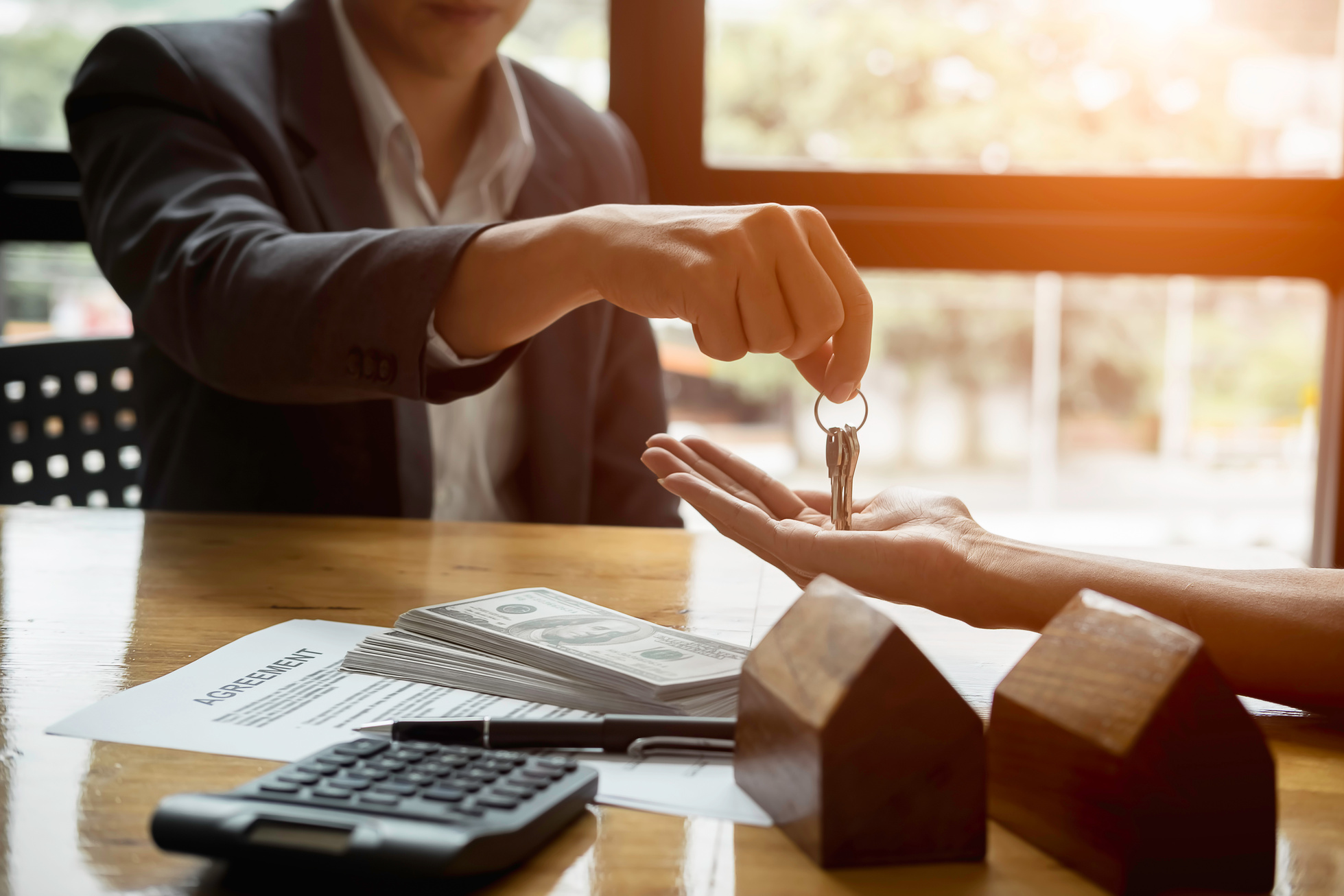 Real Estate Agent Handing House Key to His Client 