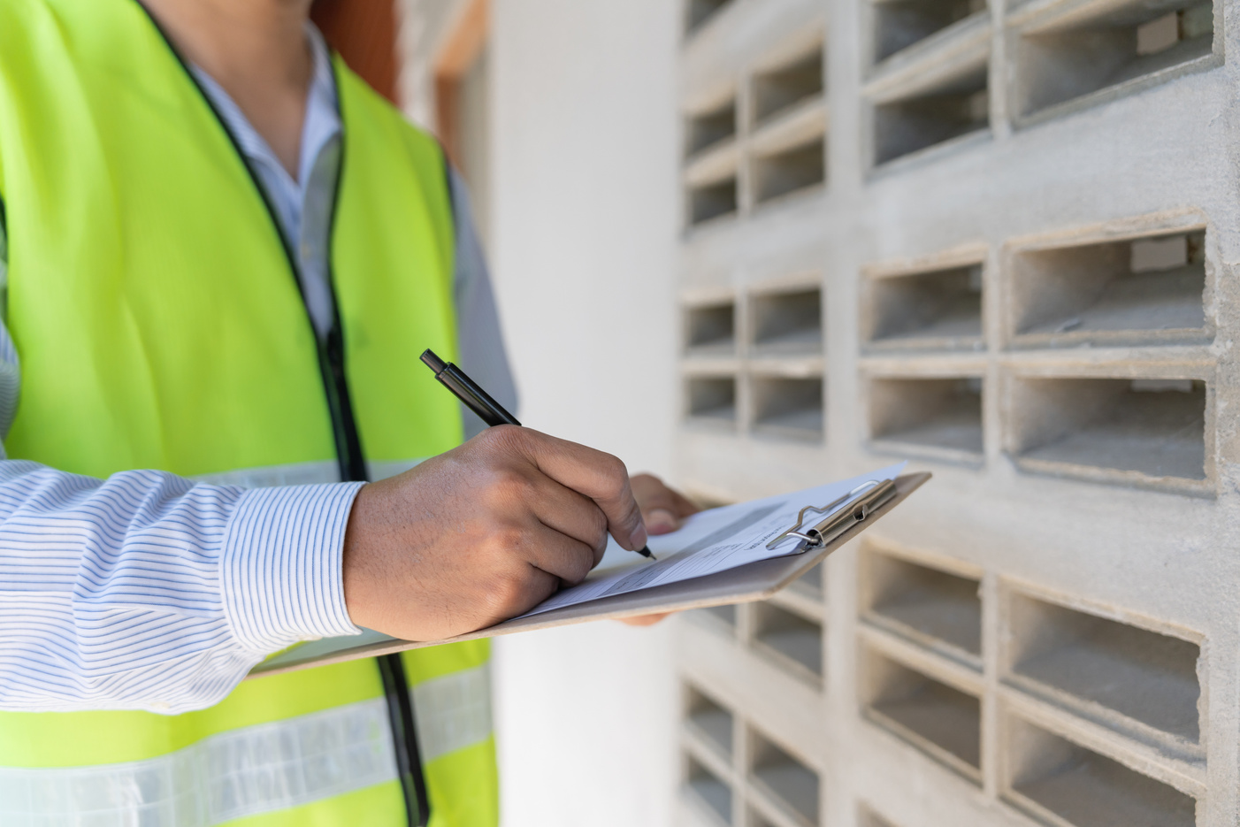 inspector or engineer is inspecting construction house using a checklist. Engineers and architects or contactor count materials for construction. Building, check, insurance house, quality, foreman.